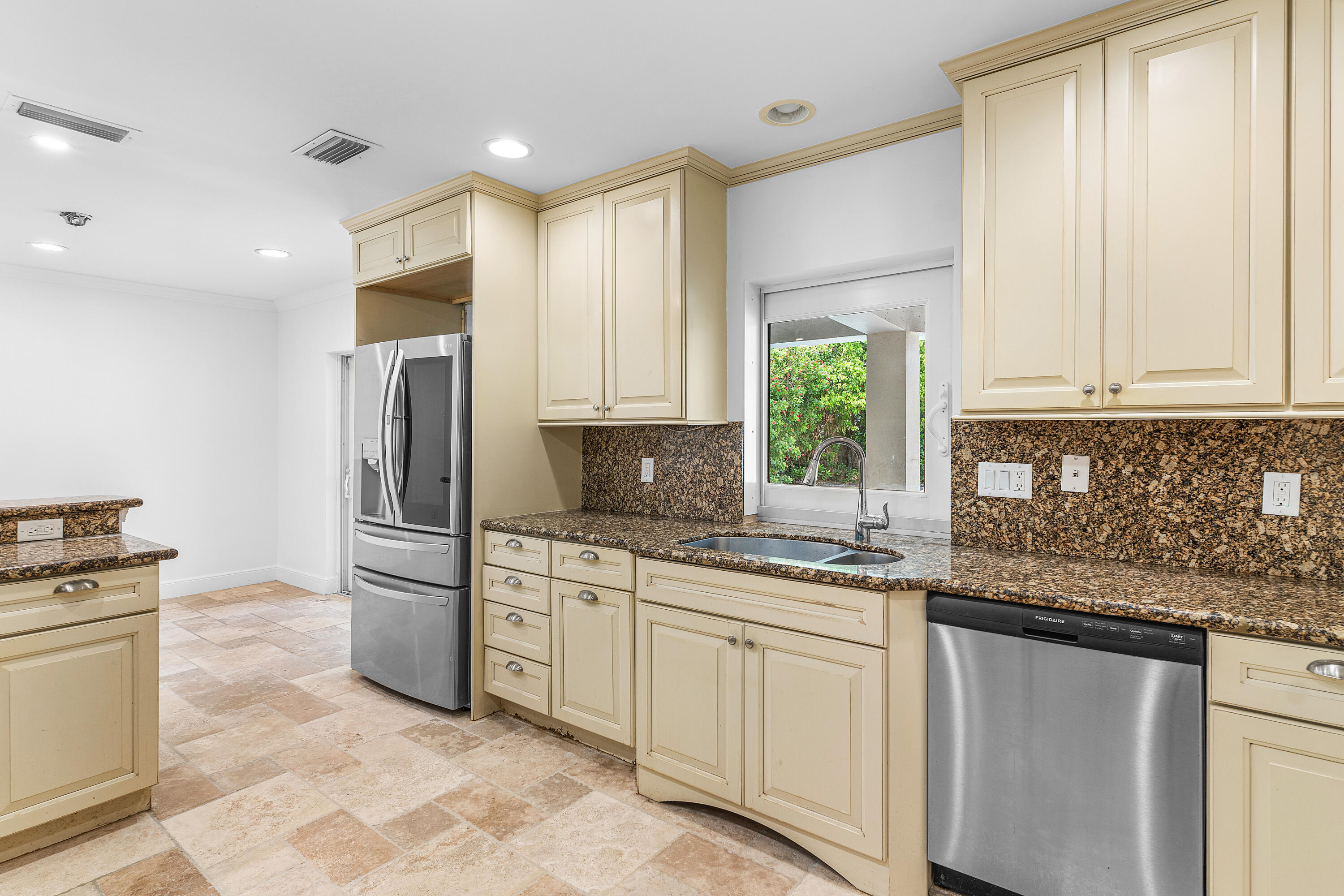 783 Valencia Drive Boca Raton, FL 33432 - Photo 14 of 45 a kitchen with white cabinets and appliances