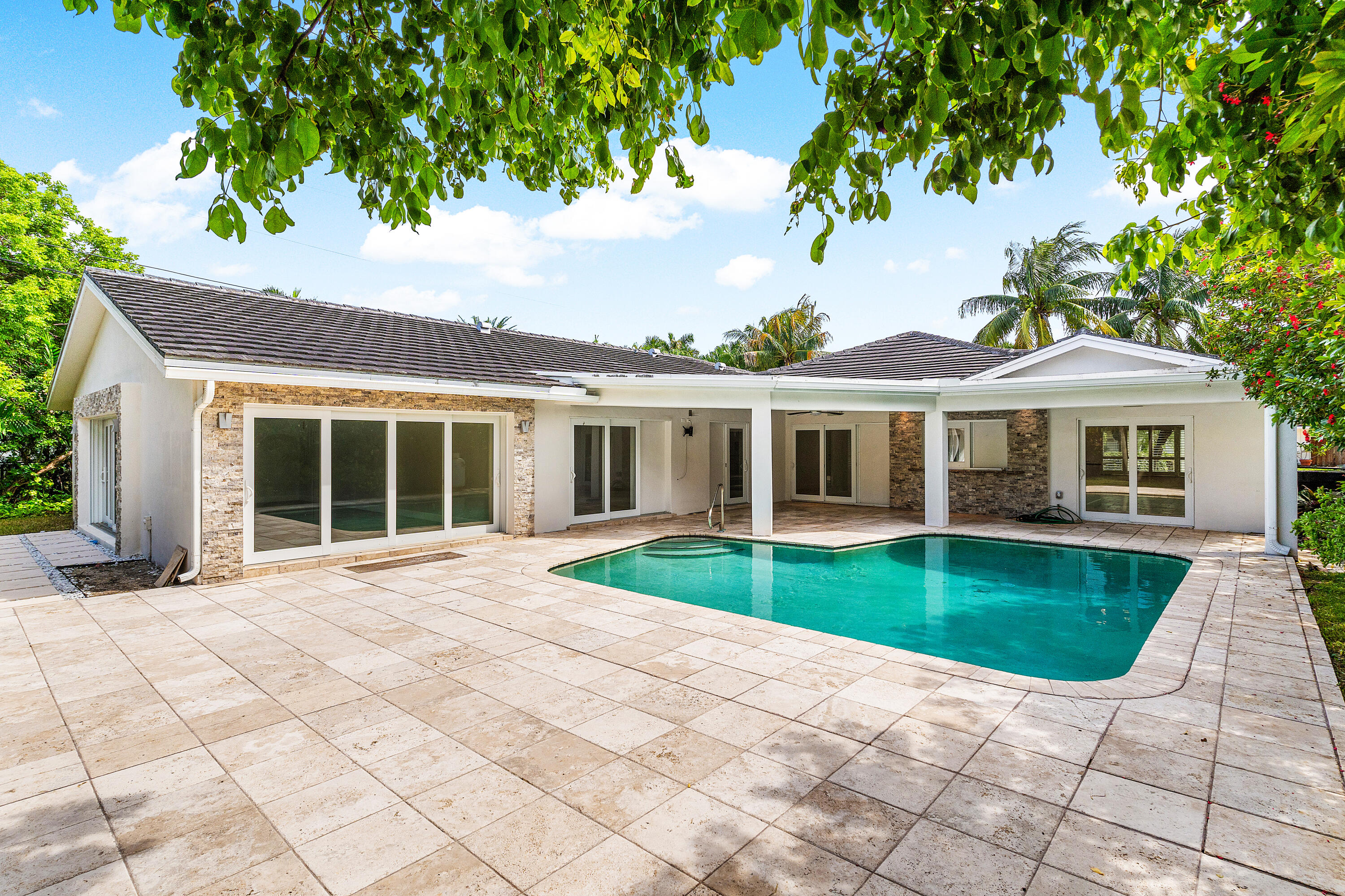 783 Valencia Drive Boca Raton, FL 33432 - Photo 16 of 45 a view of a white house with a yard plants and large tree