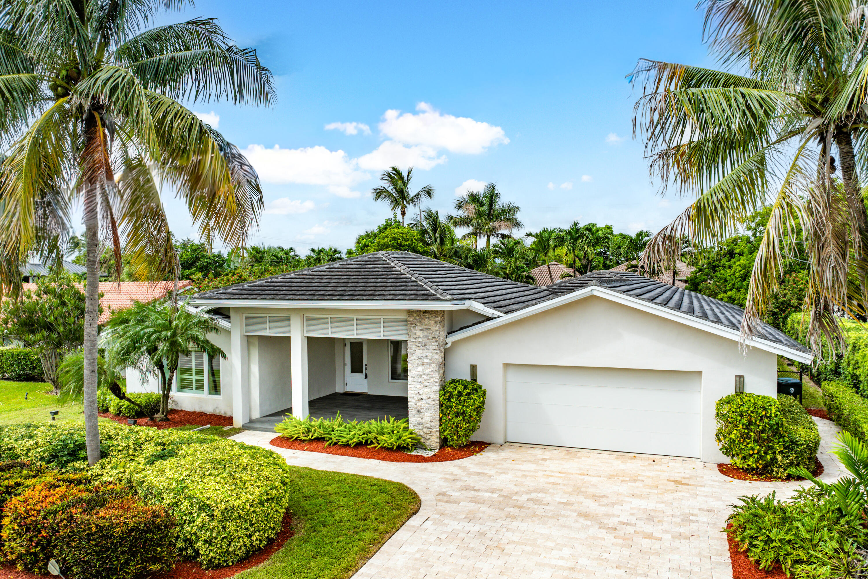 783 Valencia Drive Boca Raton, FL 33432 - Photo 2 of 45 a front view of house with yard and green space