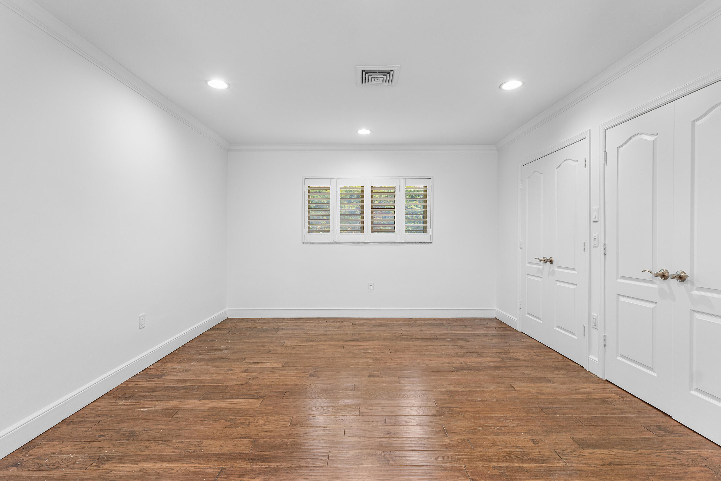783 Valencia Drive Boca Raton, FL 33432 - Photo 23 of 45 wooden floor in an empty room with a window