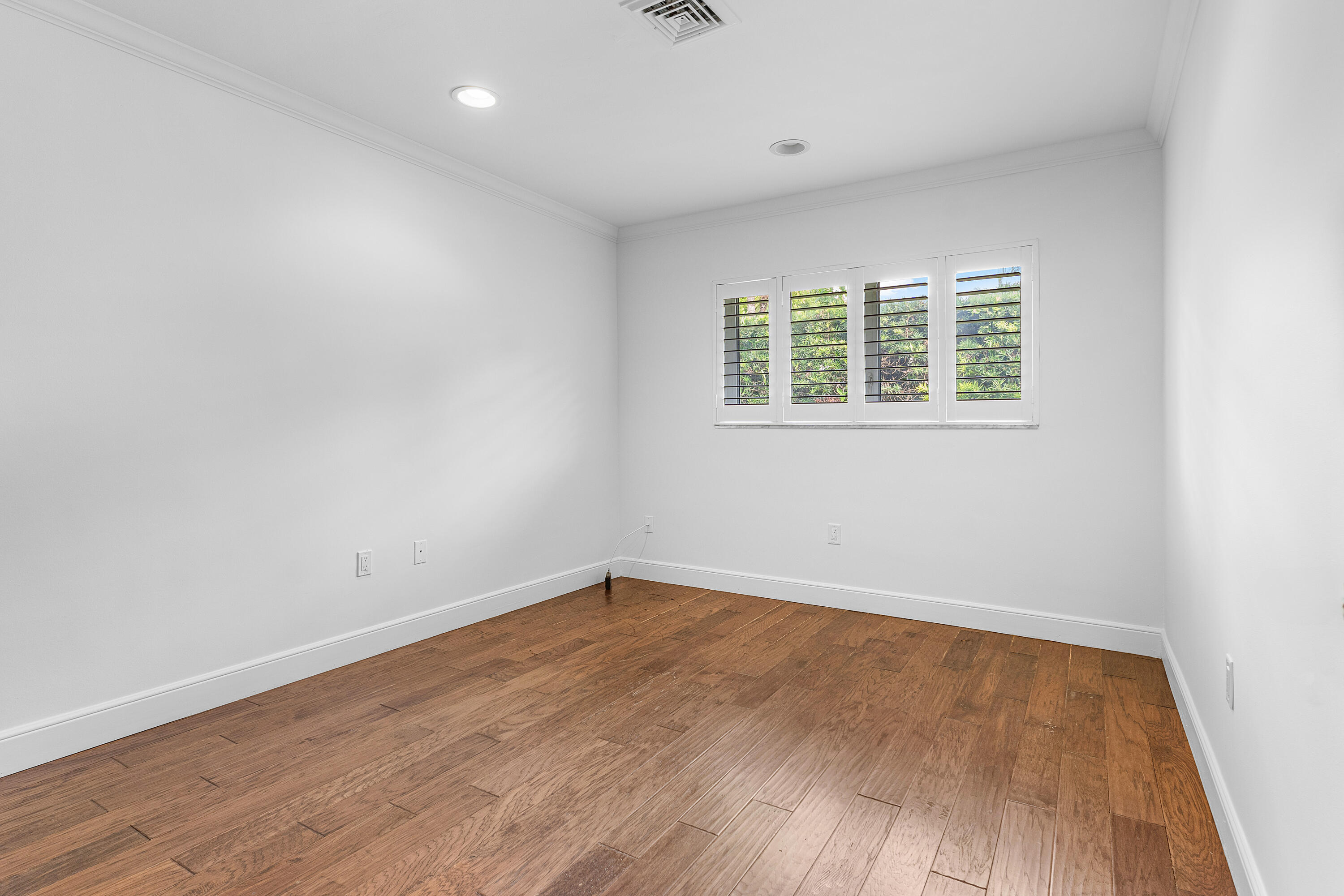 783 Valencia Drive Boca Raton, FL 33432 - Photo 29 of 45 an empty room with wooden floor and windows