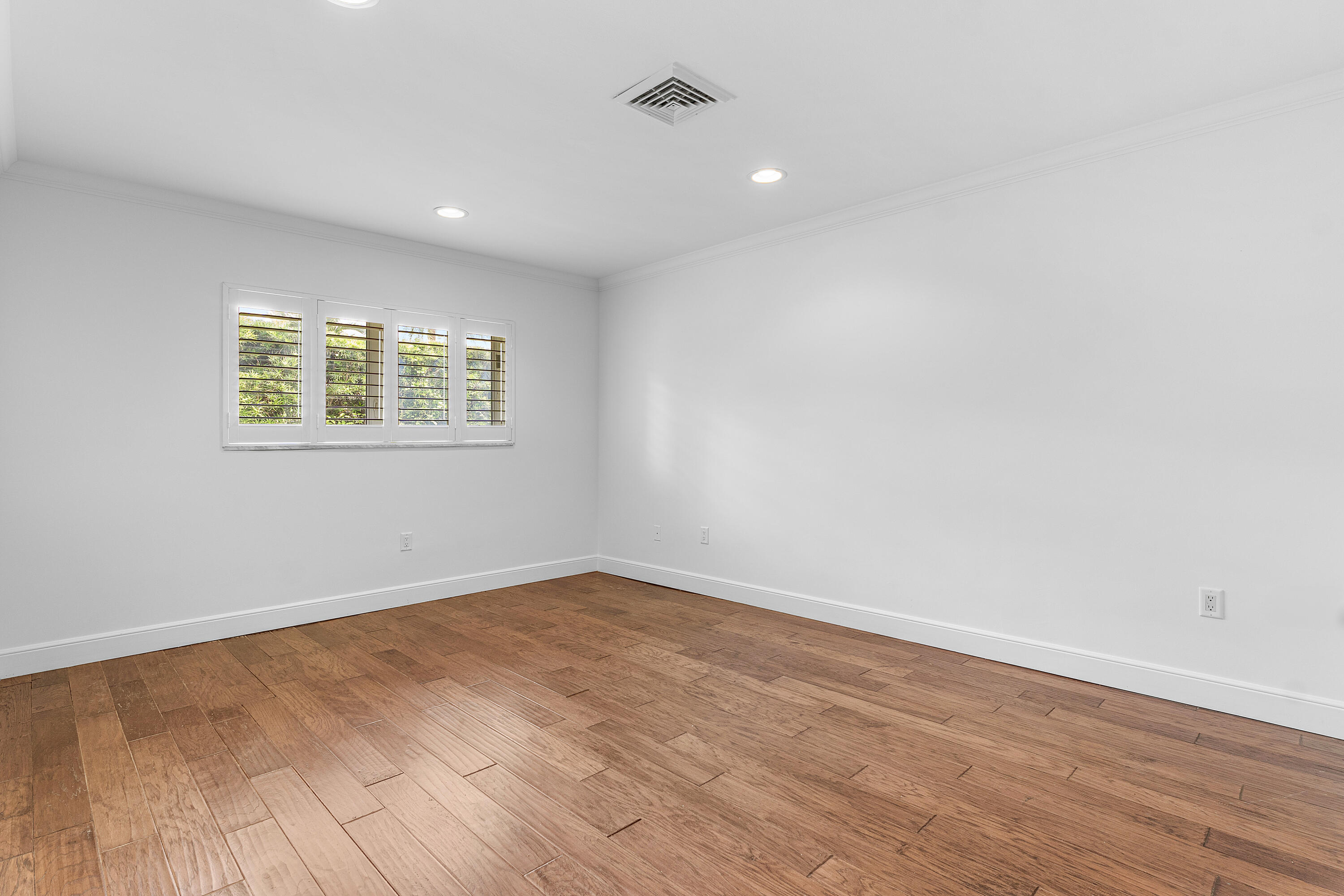 783 Valencia Drive Boca Raton, FL 33432 - Photo 31 of 45 an empty room with wooden floor and windows