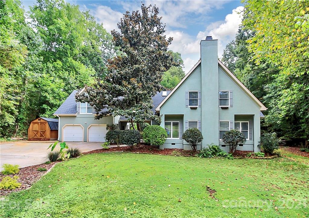 a front view of house with yard and green space