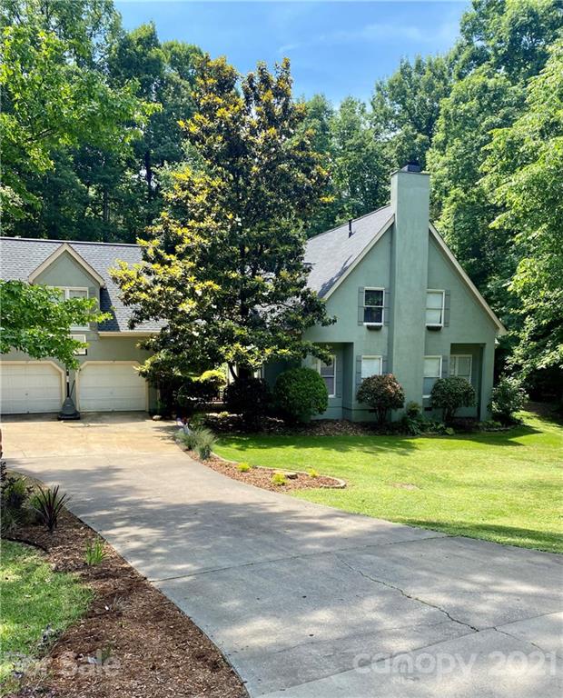 4900 Spring Lane Charlotte, NC 28213 - Photo 2 of 31 a front view of a house with yard and green space