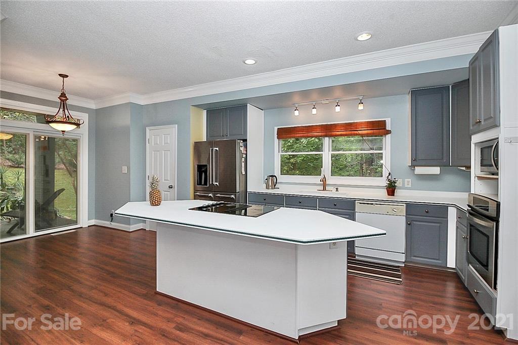 4900 Spring Lane Charlotte, NC 28213 - Photo 11 of 31 a kitchen with a sink and wooden floor