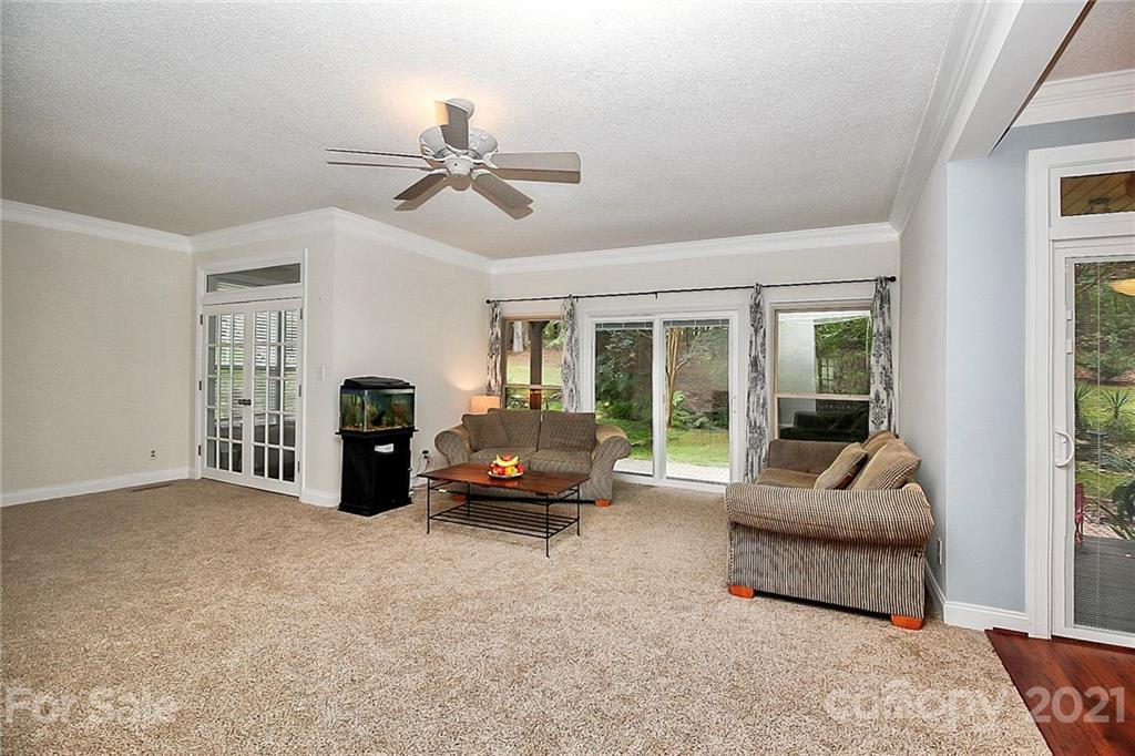 4900 Spring Lane Charlotte, NC 28213 - Photo 15 of 31 a living room with furniture and a chandelier