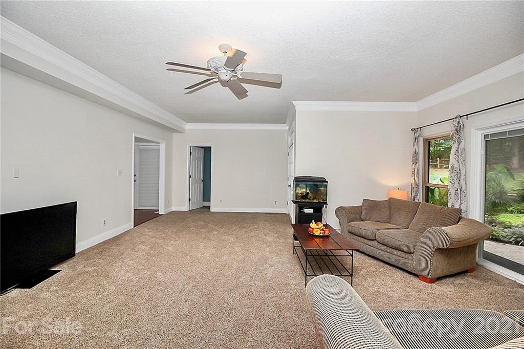 4900 Spring Lane Charlotte, NC 28213 - Photo 16 of 31 a living room with furniture and a flat screen tv