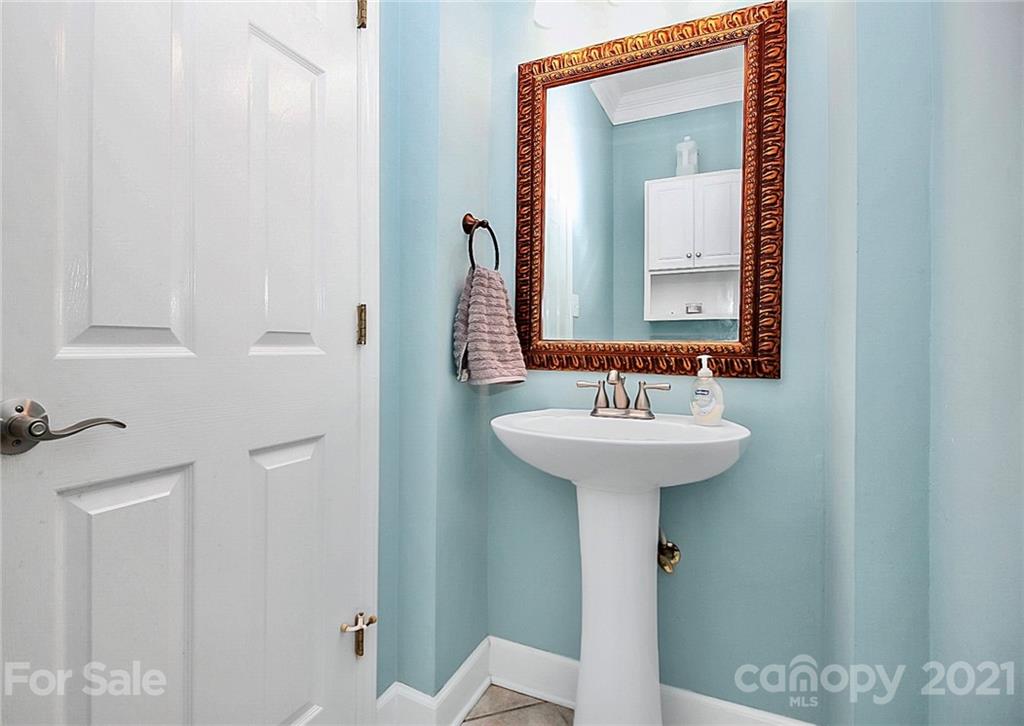 4900 Spring Lane Charlotte, NC 28213 - Photo 18 of 31 a bathroom with a sink a mirror and a toilet