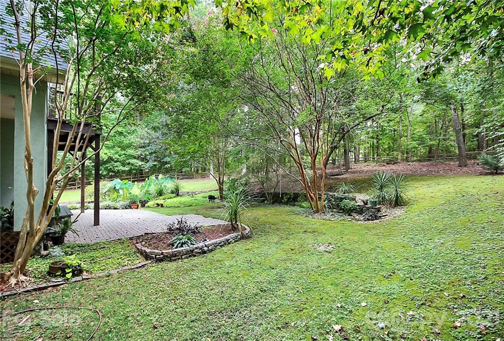 4900 Spring Lane Charlotte, NC 28213 - Photo 21 of 31 a view of backyard with swimming pool and green space