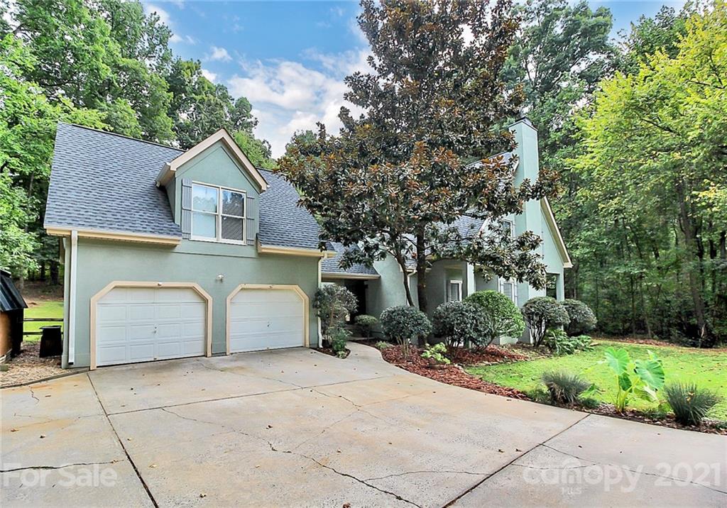4900 Spring Lane Charlotte, NC 28213 - Photo 30 of 31 a front view of a house with a yard and garage