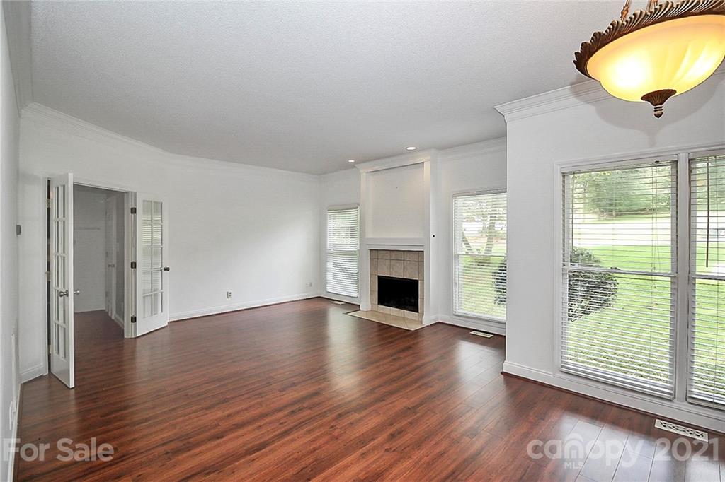 4900 Spring Lane Charlotte, NC 28213 - Photo 5 of 31 an empty room with wooden floor and windows