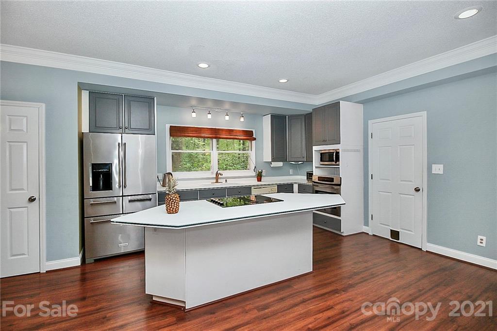 4900 Spring Lane Charlotte, NC 28213 - Photo 10 of 31 a kitchen with stainless steel appliances granite countertop a sink stove and refrigerator