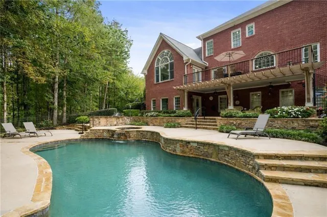 a view of a backyard with large trees