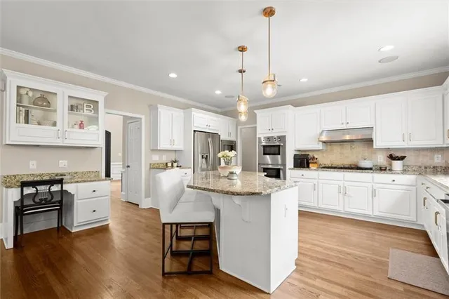 an aerial view of a swimming pool with outdoor seating and yard