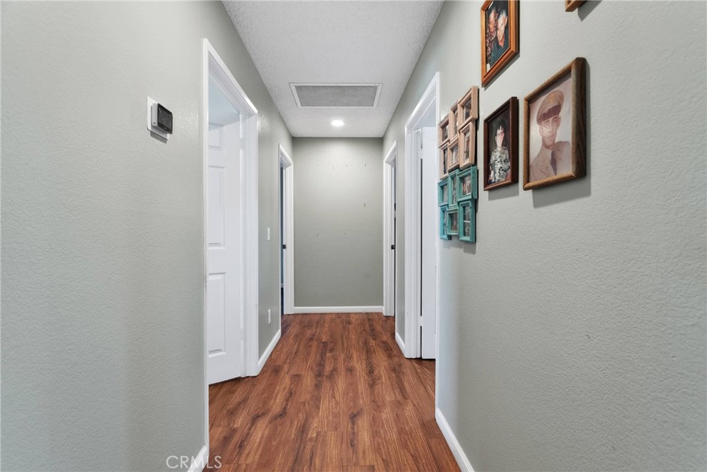 14190 Tehachapi Road Apple Valley, CA 92307 - Photo 30 of 39 a view of hallway with wooden floor
