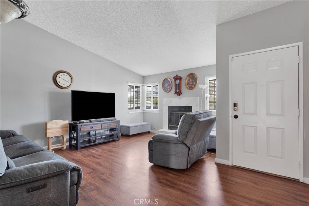 14190 Tehachapi Road Apple Valley, CA 92307 - Photo 7 of 39 a living room with furniture and a flat screen tv