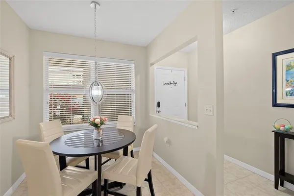 a view of a room with a table and chairs
