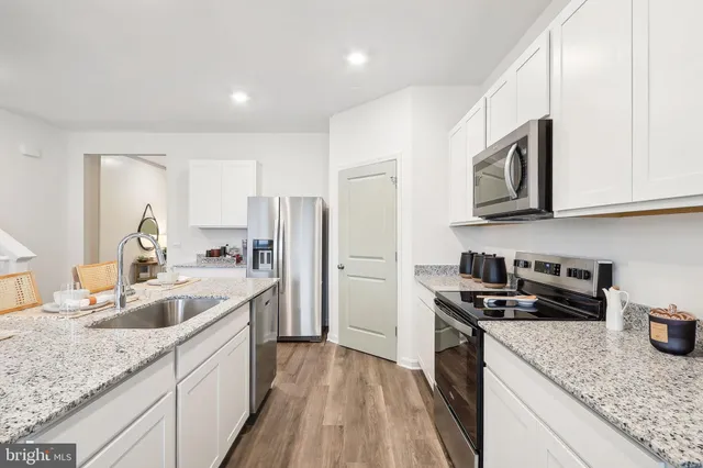 a room with a table chairs and windows