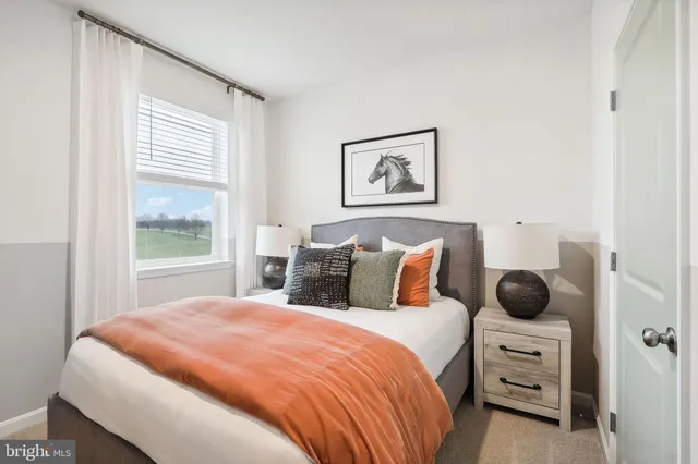 a spacious bedroom with a bed couch and large window with outer view