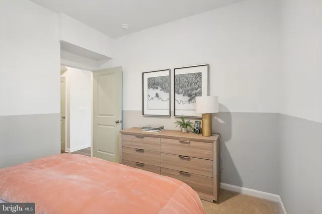 a bedroom with a bed and a window with wooden floor