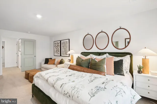 a bedroom with a bed and a mirror