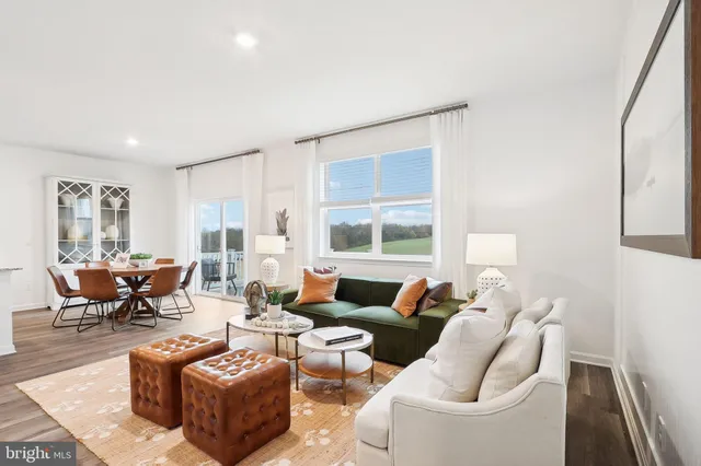a dining room with furniture a chandelier and wooden floor