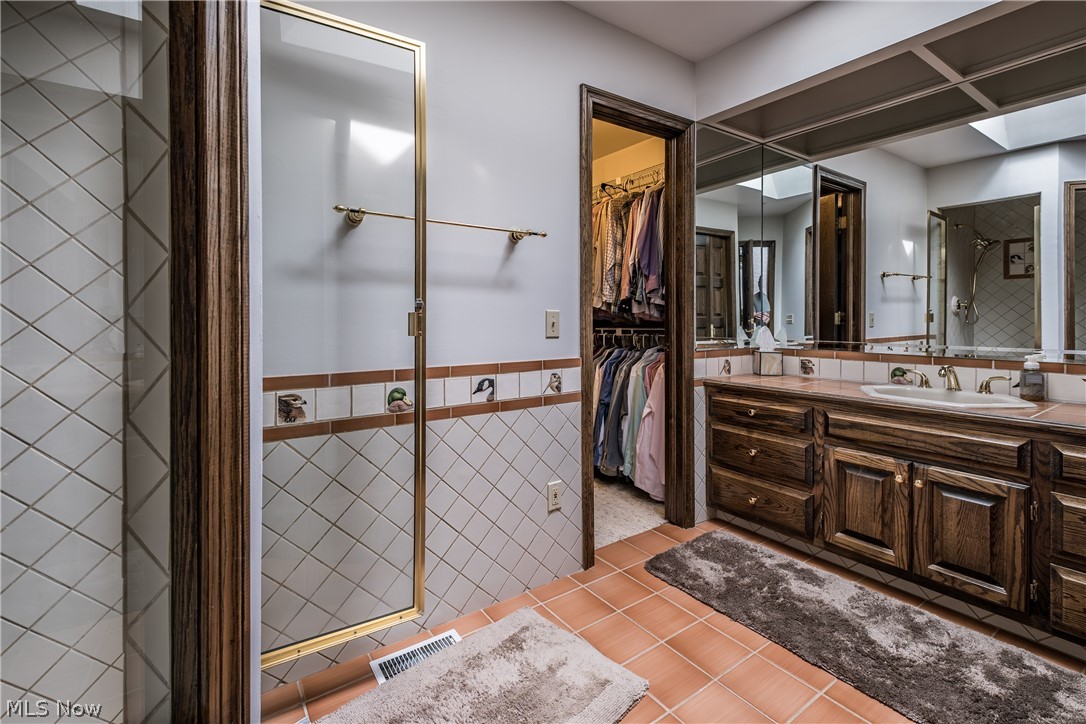 1415 Harbor Drive Northwest Canton, OH 44708 - Photo 36 of 46 2nd floor Bathroom with tile floors, a tile shower, and oversized vanity
