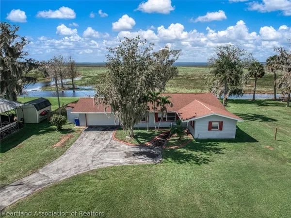 a aerial view of a house with a yard and a garage