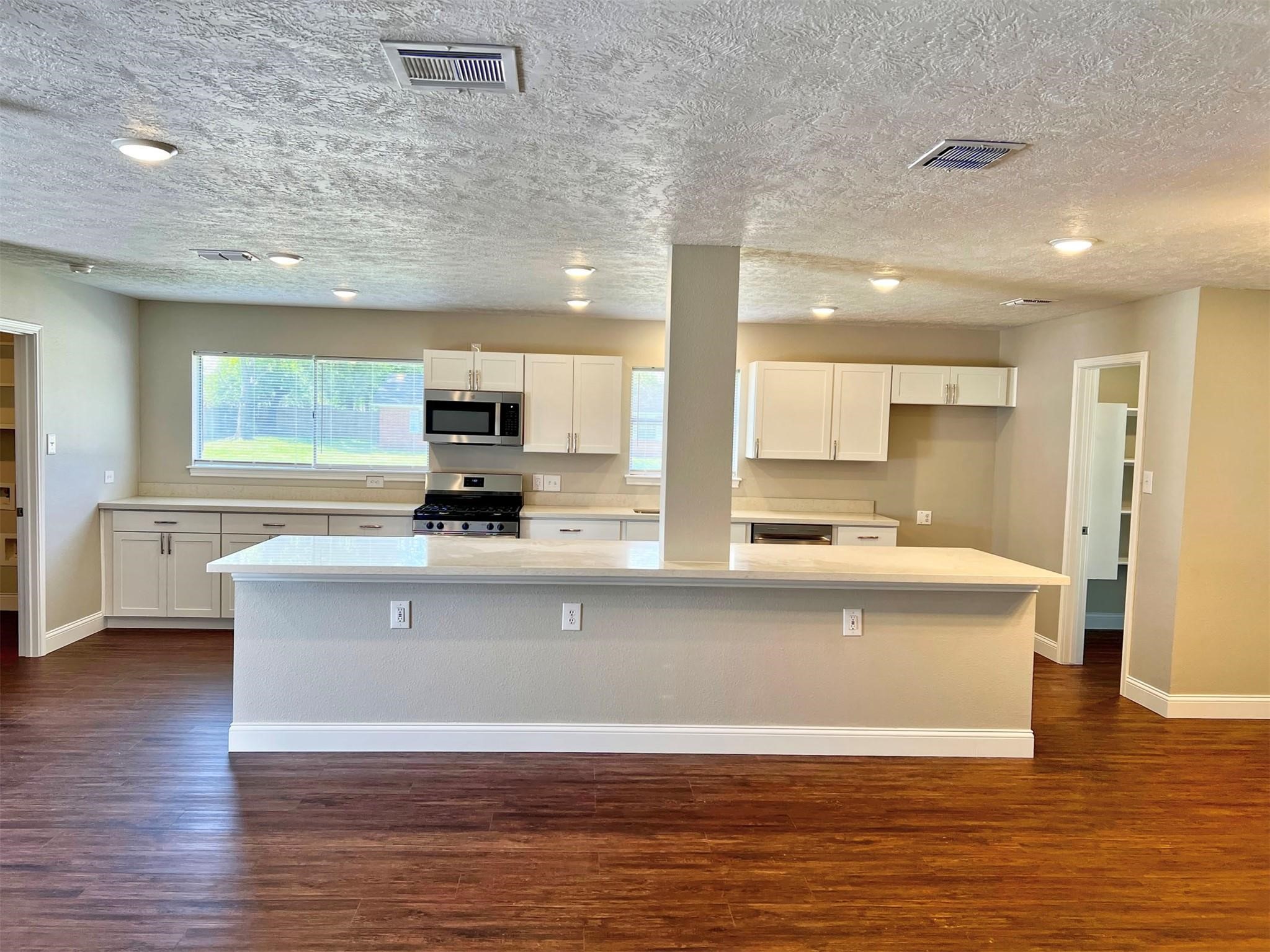 415 Sevenhampton Lane Houston, TX 77015 - Photo 12 of 32 a view of kitchen with stainless steel appliances granite countertop a stove and a large window