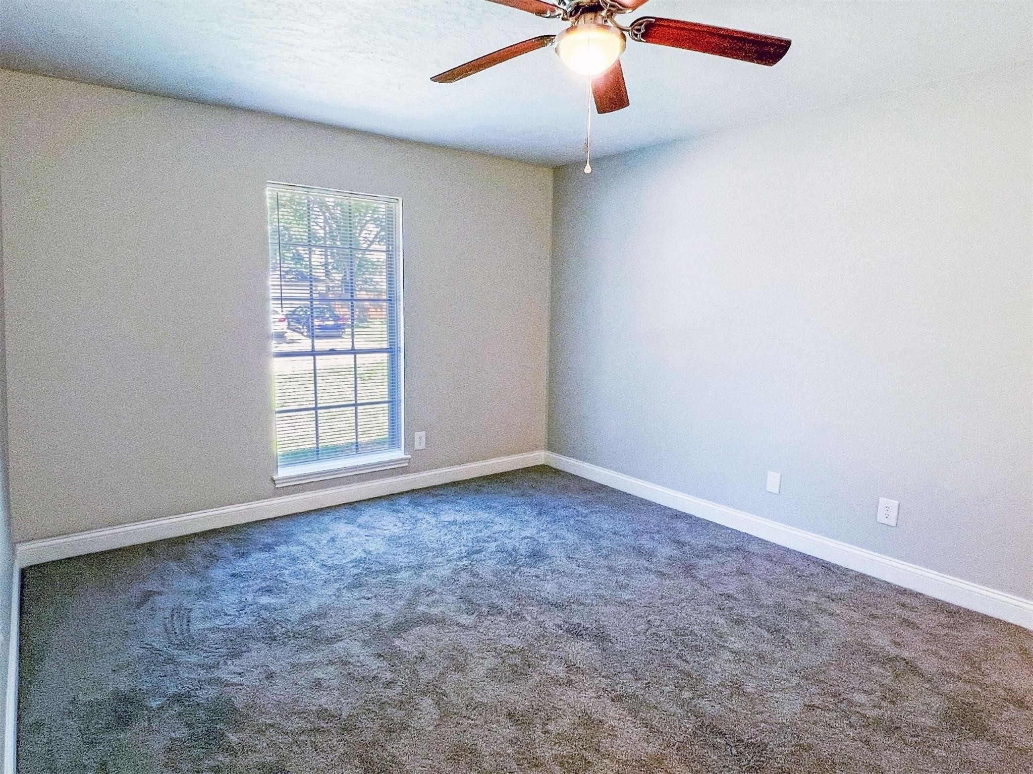 415 Sevenhampton Lane Houston, TX 77015 - Photo 17 of 32 an empty room with windows and fan