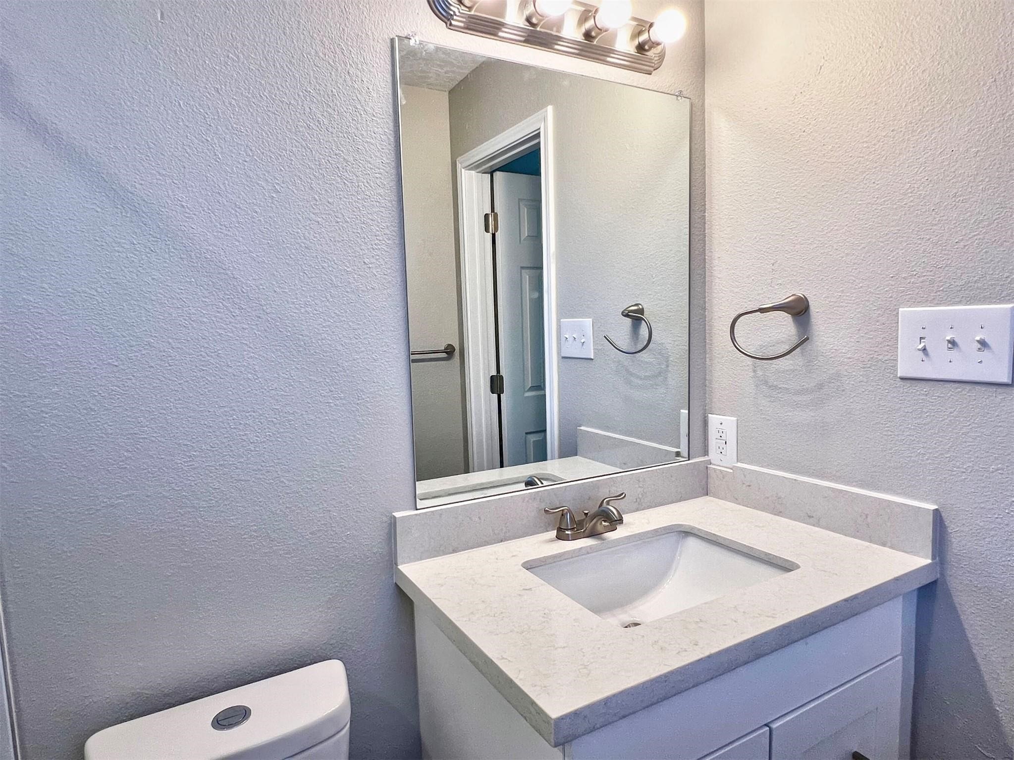 415 Sevenhampton Lane Houston, TX 77015 - Photo 20 of 32 a bathroom with a sink and a mirror with toilet