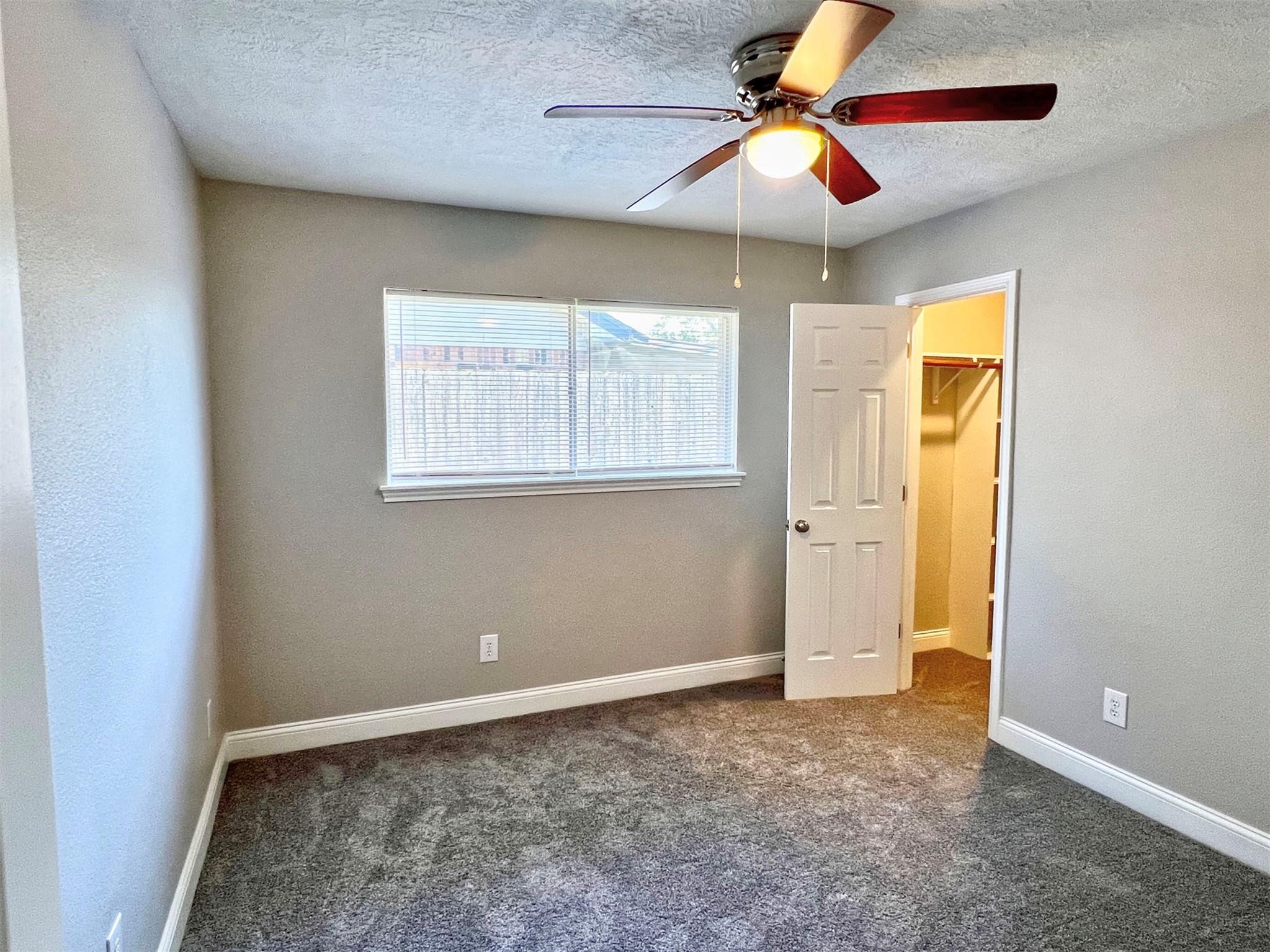 415 Sevenhampton Lane Houston, TX 77015 - Photo 22 of 32 a view of an empty room with window and chandelier fan