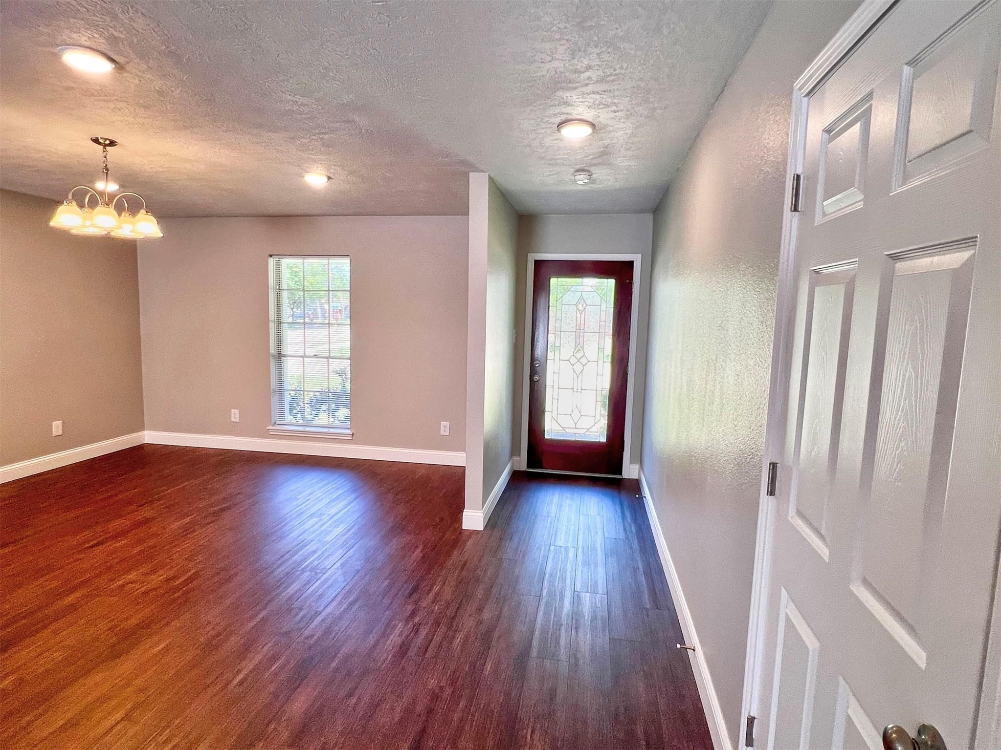 415 Sevenhampton Lane Houston, TX 77015 - Photo 10 of 32 an empty room with wooden floor and windows