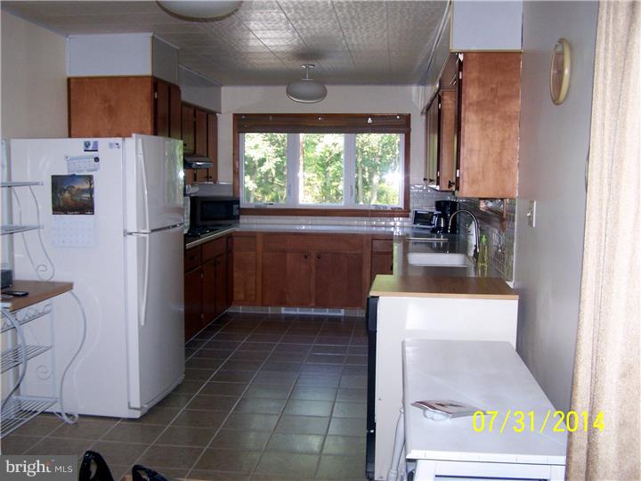 224 Friendship Road Southampton, NJ 08088 - Photo 8 of 11 a kitchen with a refrigerator and a stove