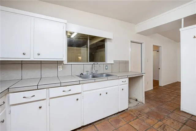 a bathroom with a sink and cabinets