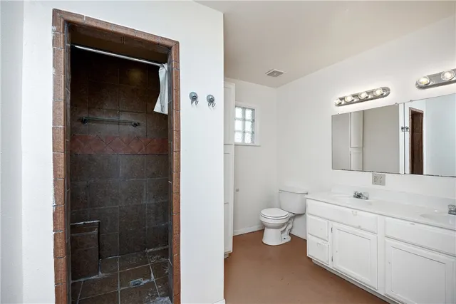 a bathroom with a toilet sink and shower