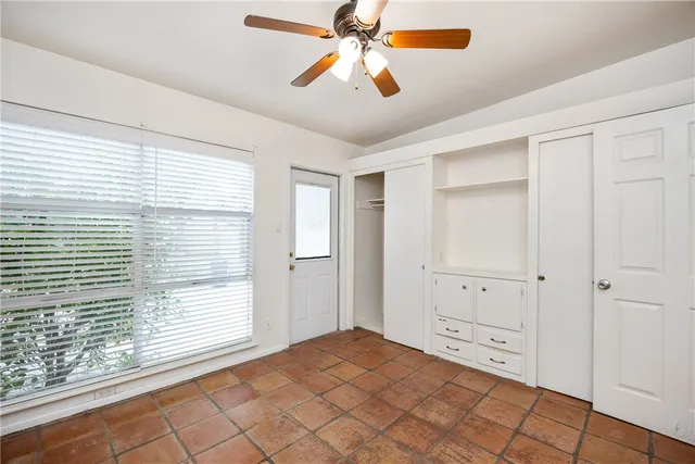 a view of a room with window and cabinet area