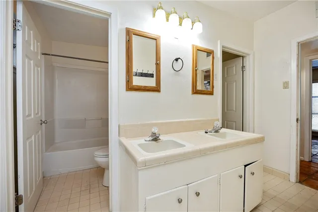 a bathroom with a sink a mirror and a shower