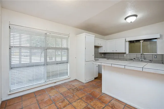 a kitchen with stainless steel appliances granite countertop a sink and a stove
