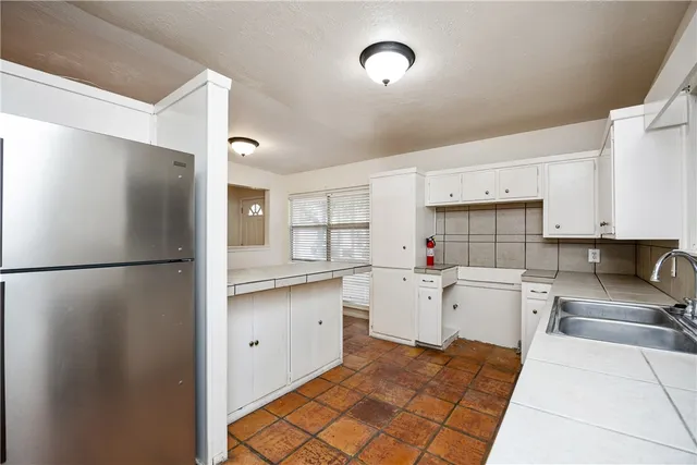 a kitchen with a refrigerator and a sink