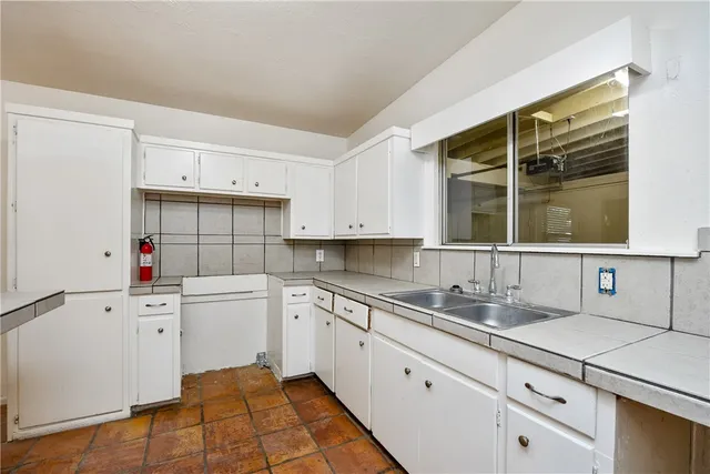 a kitchen with a sink stove and cabinets