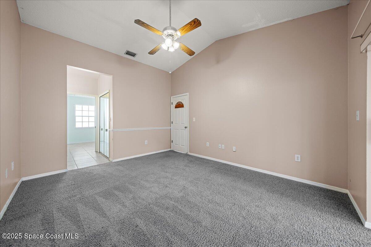 875 Evergreen Place Rockledge, FL 32955 - Photo 13 of 27 an empty room with windows and ceiling fan
