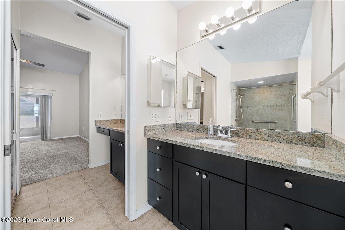 875 Evergreen Place Rockledge, FL 32955 - Photo 15 of 27 a bathroom with a granite countertop sink mirror and double