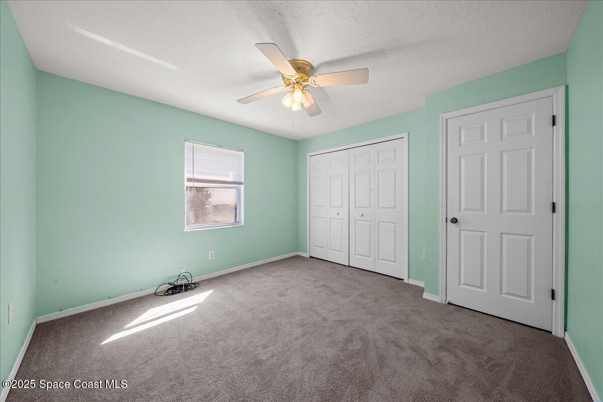 875 Evergreen Place Rockledge, FL 32955 - Photo 17 of 27 an empty room with a ceiling fan and a window