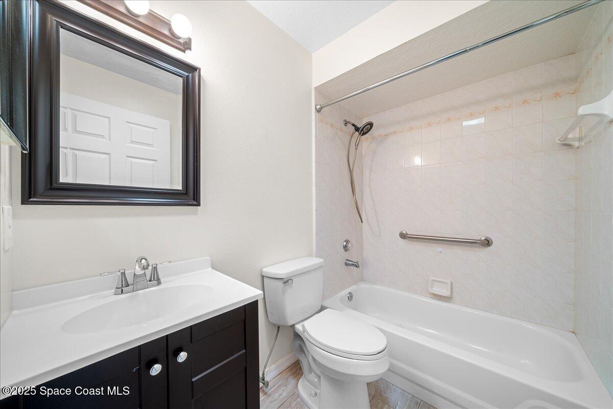 875 Evergreen Place Rockledge, FL 32955 - Photo 18 of 27 a bathroom with a sink a toilet and a bathtub
