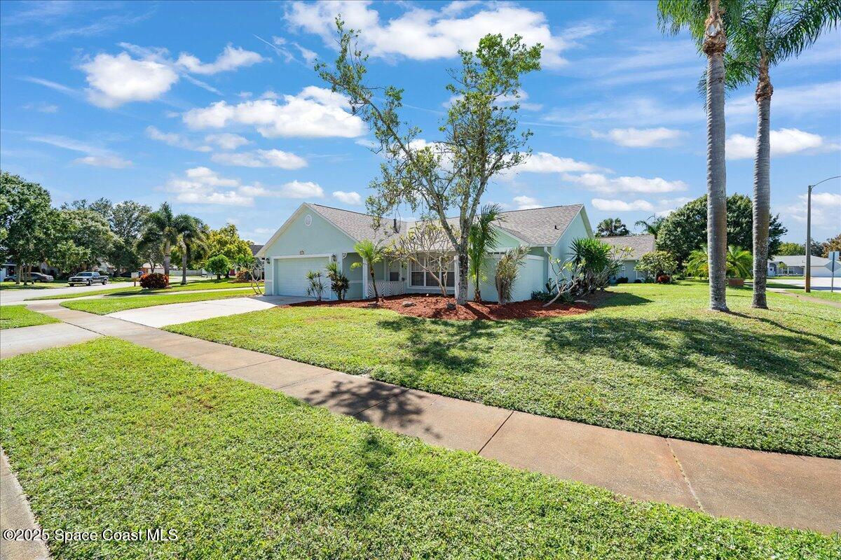 875 Evergreen Place Rockledge, FL 32955 - Photo 2 of 27 a view of a house with a yard and potted plants