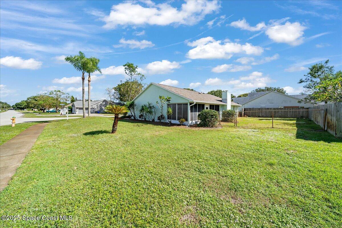 875 Evergreen Place Rockledge, FL 32955 - Photo 24 of 27 a house view with swimming pool and trees in the background