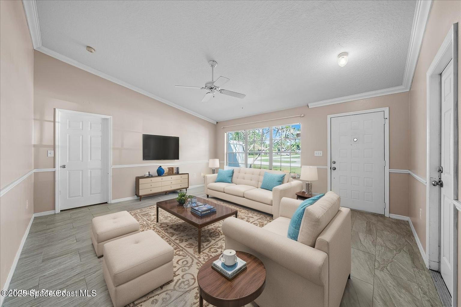 875 Evergreen Place Rockledge, FL 32955 - Photo 3 of 27 a living room with furniture and a flat screen tv