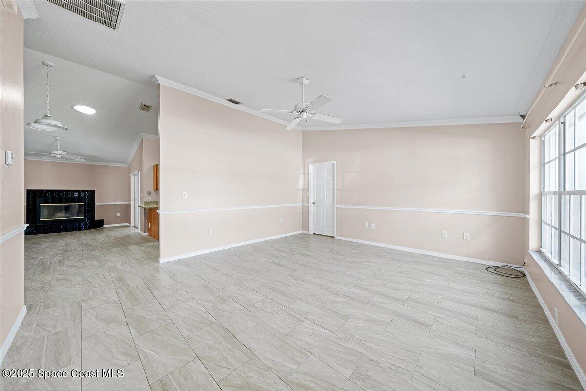 875 Evergreen Place Rockledge, FL 32955 - Photo 5 of 27 wooden floor in an empty room with a window