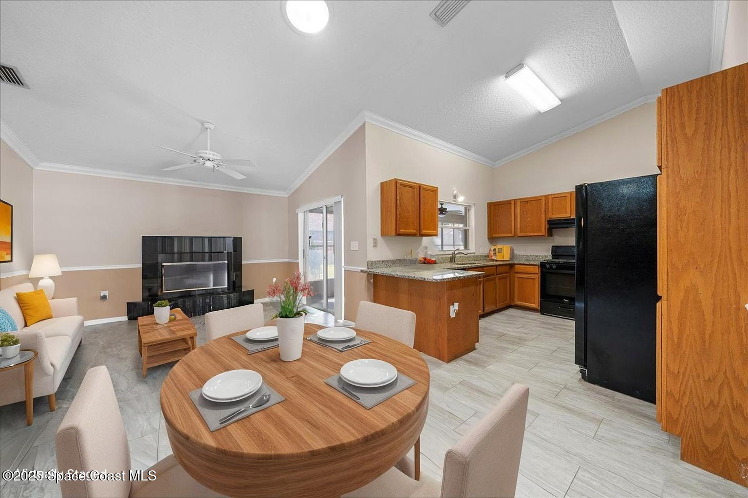 875 Evergreen Place Rockledge, FL 32955 - Photo 6 of 27 a living room with stainless steel appliances a dining table and kitchen view